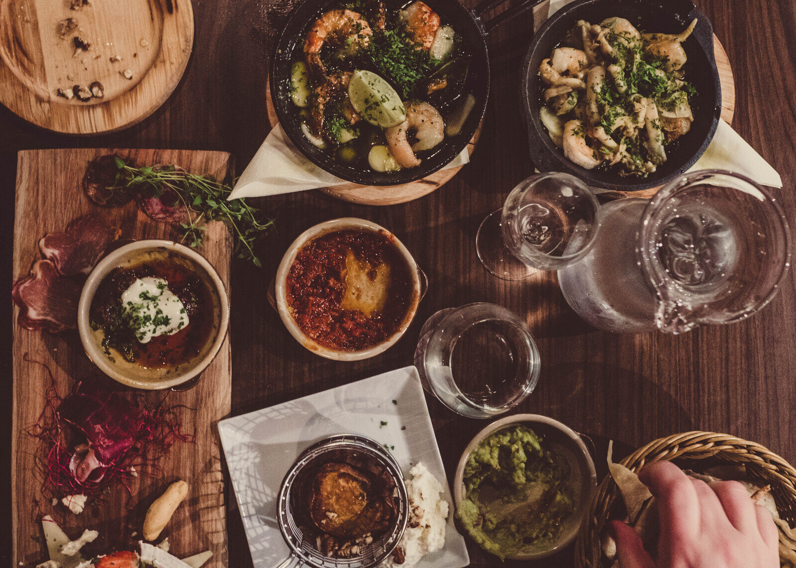 table full of small plates and drinks at tempe bar